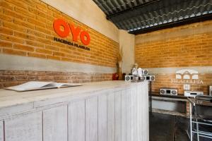 a bar with an orange sign on a brick wall at Capital O Hacienda Filadelfia, El Atorón, Irapuato in Irapuato +40 photos