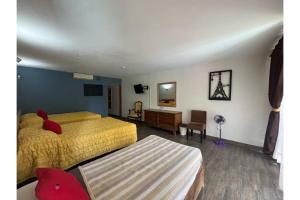 Postel nebo postele na pokoji v ubytování Capital O Gran Hotel Campestre