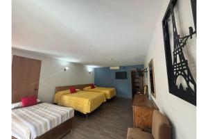 Postel nebo postele na pokoji v ubytování Capital O Gran Hotel Campestre