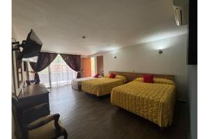 Postel nebo postele na pokoji v ubytování Capital O Gran Hotel Campestre