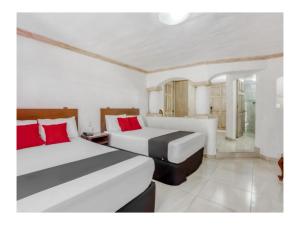 Postel nebo postele na pokoji v ubytování Capital O Gran Hotel Campestre