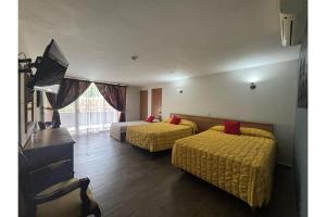 Postel nebo postele na pokoji v ubytování Capital O Gran Hotel Campestre