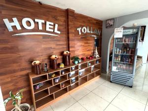 a hotel sign on a wall next to a refrigerator at OYO Hotel Familiar Tollan Cholula in Cholula