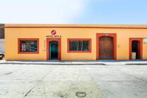 a building with two doors and a sign on it at OYO Hotel Y Restaurante Mitla, Oaxaca in San Pablo Villa de Mitla