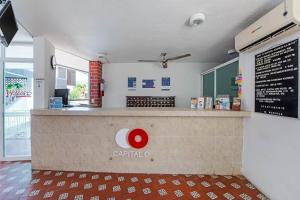 a restaurant with a counter with a sign on it at Capital O Hotel El Mejicano, Acapulco in Acapulco