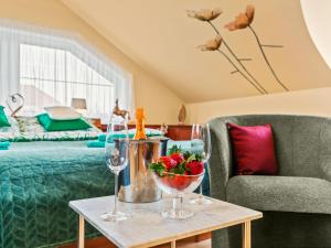 a room with a bed and a table with wine glasses at Villa Garden & Terrace Villa by Interhome in Prague