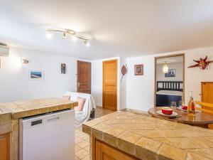 a kitchen with a counter top and a table at Apartment Mimosas by Interhome in Carqueiranne