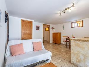 a living room with a couch and a table at Apartment Mimosas by Interhome in Carqueiranne