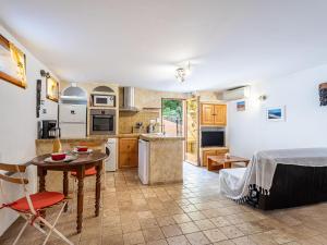 a kitchen and living room with a table and chairs at Apartment Mimosas by Interhome in Carqueiranne