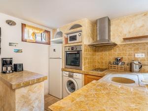 a kitchen with a refrigerator and a washer and dryer at Apartment Mimosas by Interhome in Carqueiranne +22 photos