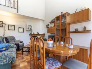 a kitchen and living room with a wooden table and chairs at Villa Palmera I by Interhome in L'Ametlla de Mar