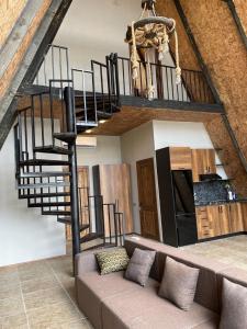 a living room with a couch and a spiral staircase at Holiday Home in Vǝndam +10 photos