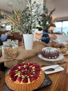 a table topped with a pie with strawberries on top at Charming Cottage Iesolana in Pogi