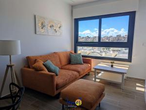 a living room with a couch and a large window at Luxury penthouse with Solarium and Com Pool VM78 in Villamartin