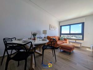 a living room with a table and chairs and a couch at Luxury penthouse with Solarium and Com Pool VM78 in Villamartin