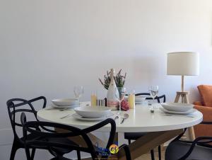 a white table with four chairs and a white table top at Luxury penthouse with Solarium and Com Pool VM78 in Villamartin