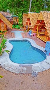 a small swimming pool in front of a resort at Bamboo Village in Ban Tai