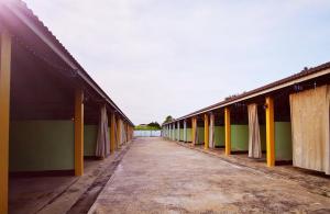 an empty hallway of a building with curtains on it at โรงแรมฟอร์เลิฟ รังสิต in Ban Khlong Kao (6)