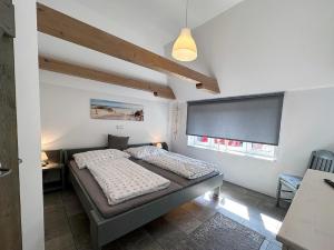 a small bedroom with a bed and a window at Ferienhaus Fresen Hus Humptrup in Humptrup