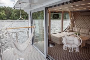 a hammock on the back of a boat at Nena Hausboot in Berlin