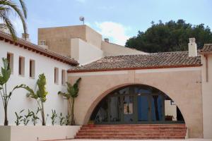 a house with an archway in front of it at Finca Olivar Country Boutique Hotel in Benissa