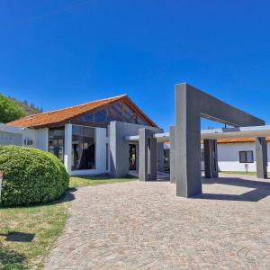 a large white building with a red roof at Harmonie Hotel De Montaña - Adults only in Villa General Belgrano