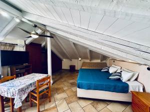 a bedroom with a bed and a table in a room at Eva Studios in Kassiopi