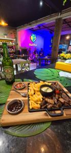 a tray of meat and french fries and a bottle of beer at Porto Rico - Hotesol in Porto De Galinhas