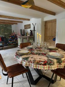 a dining room table with a christmas tree in the background at Havre de Paix in Hermelinghen +30 photos