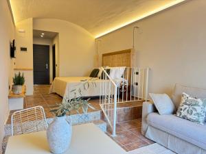 a living room with a bed and a couch at Finca Olivar Country Boutique Hotel in Benissa