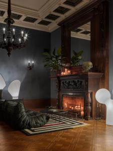 a living room with a fireplace and a mirror at The Benjamin House in Rīga
