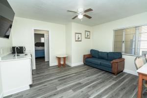a living room with a couch and a table at Sunrise Resort Motel South in Clearwater Beach