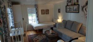 a small living room with a couch and a bed at Ålesund New Guesthouse in Ålesund
