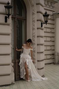 a woman in a wedding dress standing in a doorway at The Benjamin House in Rīga