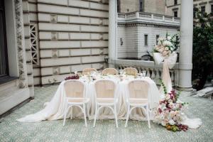 a wedding table with chairs and flowers on a porch at The Benjamin House in Rīga