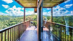 a balcony with a view of the mountains at Teniqua Treetops in Sedgefield
