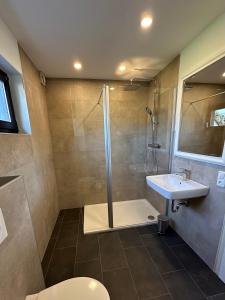 a bathroom with a shower and a sink at Gästehaus Heimatliebe in Heimbach +16 photos