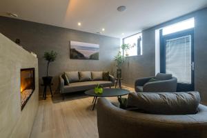 a living room with a couch and a fireplace at Bed & Wellness De Leilinde in Nieuwe-Niedorp