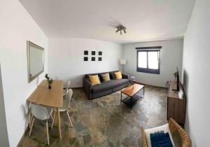 a living room with a couch and a table at Relájate en planta alta - Playa B in Playa Blanca +22 photos