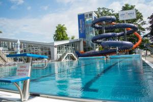 a pool with a water slide in front of a building at Ondrašovská skala in Ondrašová