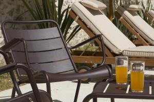 two glasses of beer sitting on a table at Villa Meridia in Nîmes