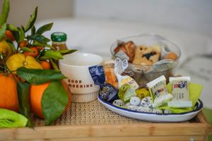 a table with a tray of food and a bowl of fruit at B&B Green Valley in Cava deʼ Tirreni