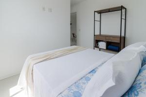 En eller flere senge i et værelse på Varanda Rede Vista Mar 8 Andar • Ed Palmer • NOMDS