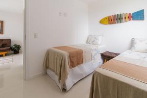 En eller flere senge i et værelse på Varanda Rede Vista Mar 8 Andar • Ed Palmer • NOMDS