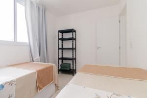 En eller flere senge i et værelse på Varanda Rede Vista Mar 8 Andar • Ed Palmer • NOMDS + 24 billeder