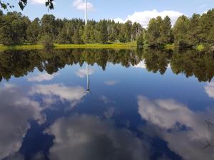 a reflection of the sky in a lake at Ferienwohnungen Schönwald in Schonwald im Schwarzwald