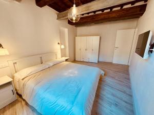 a bedroom with a large bed and a wooden floor at Il Pescatore in Marciana Marina