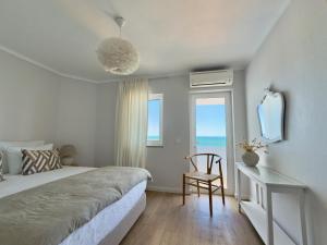 a bedroom with a bed and a desk and a window at Apartamentos Rossio Mar in Albufeira +52 photos