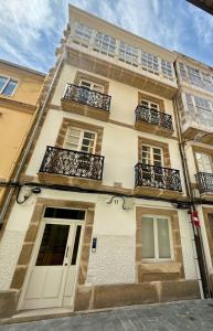 a building with balconies on a city street at housingcoruña PLAZA DE ESPAÑA in A Coruña