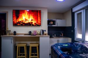 a kitchen with a fireplace on the wall at Appartement Jacuzzi in Strasbourg
